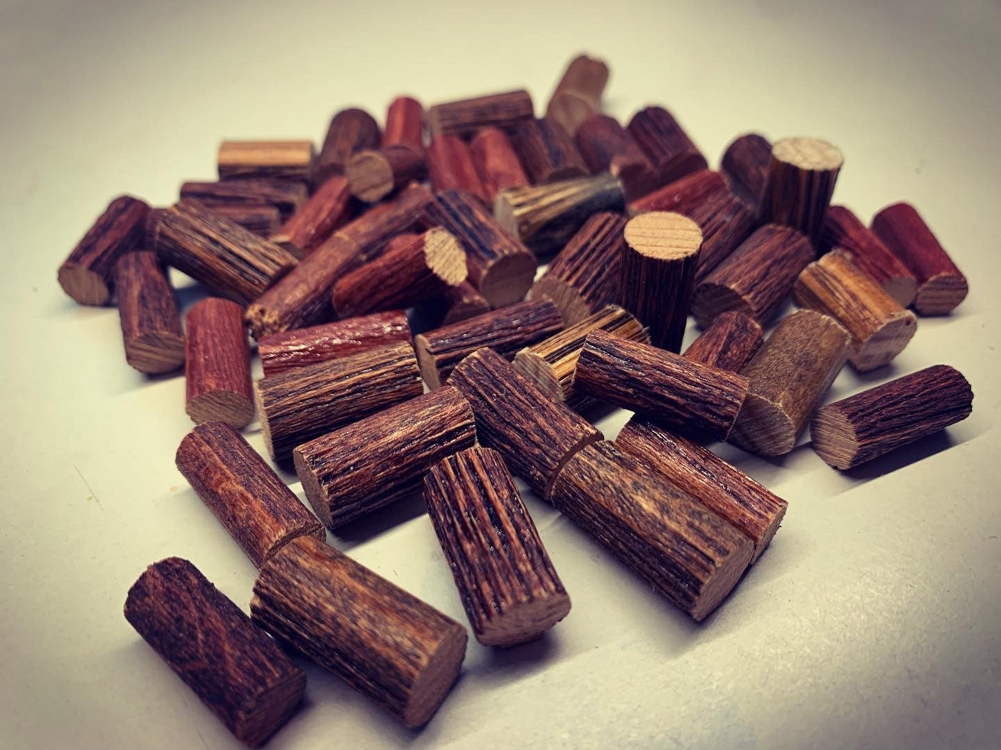 Stack of 30 miniature logs on white background