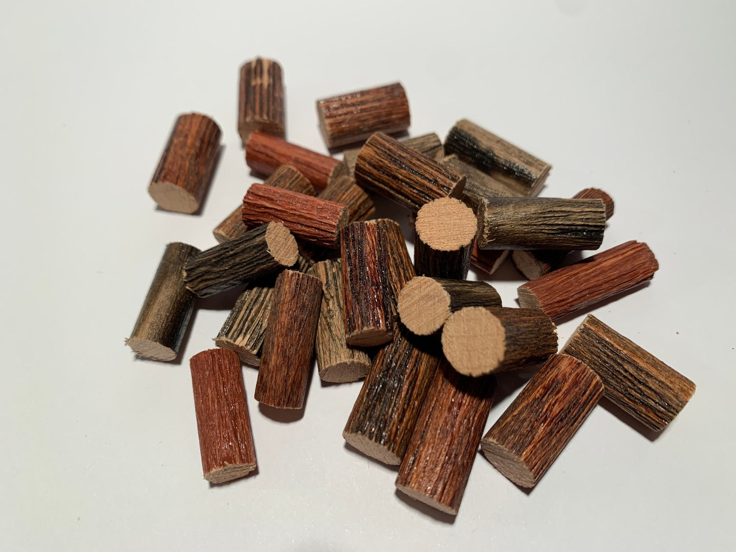 Stack of 20 miniature logs on white background