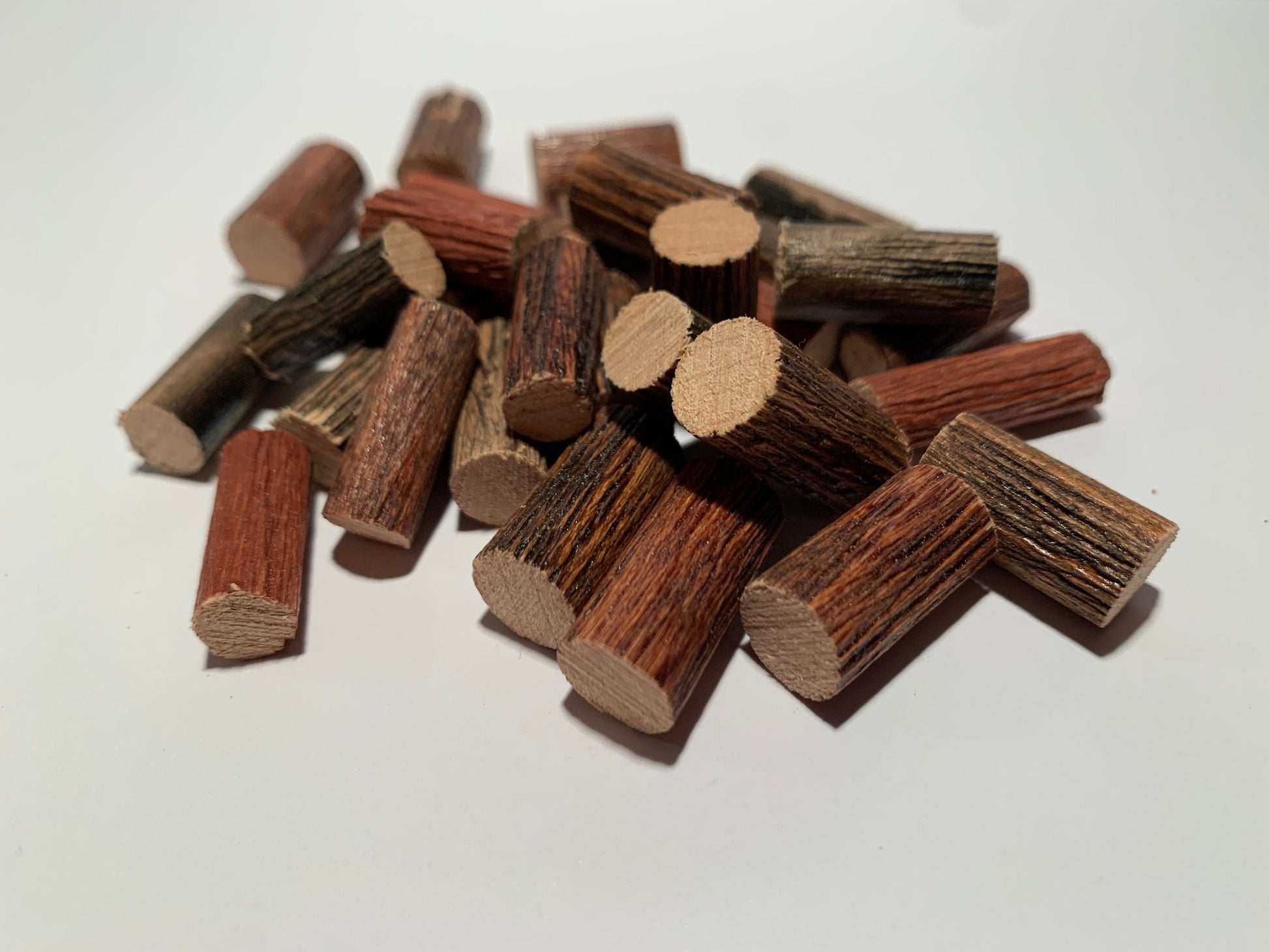 Stack of 20 miniature logs on white background